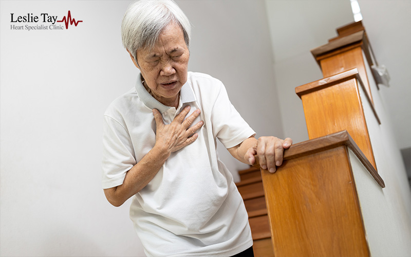 Asian woman experiencing chest discomfort