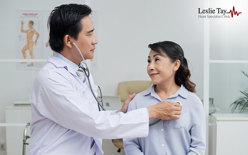 Heart specialist examining patient to lower second heart attack risk.