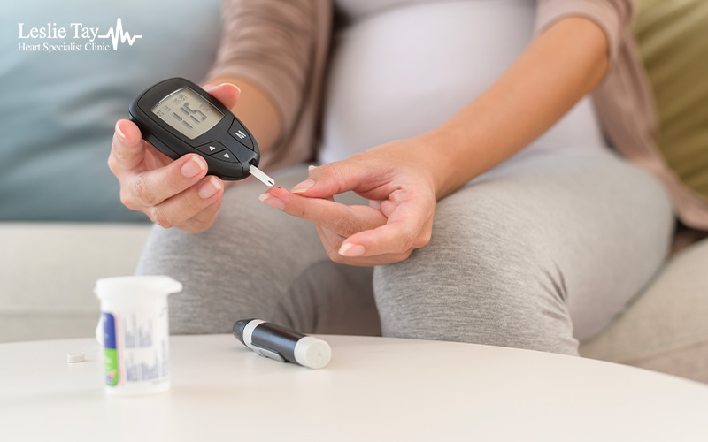 Patient monitoring blood sugar to manage heart disease risk.
